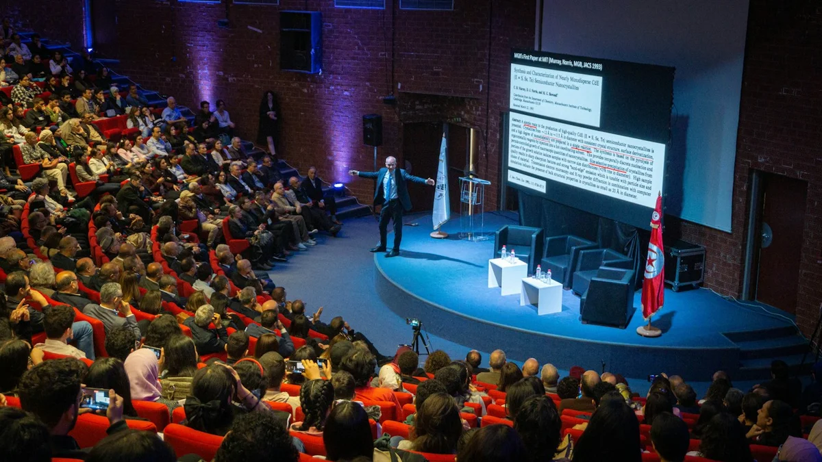 Speaker and seated audience at a conference