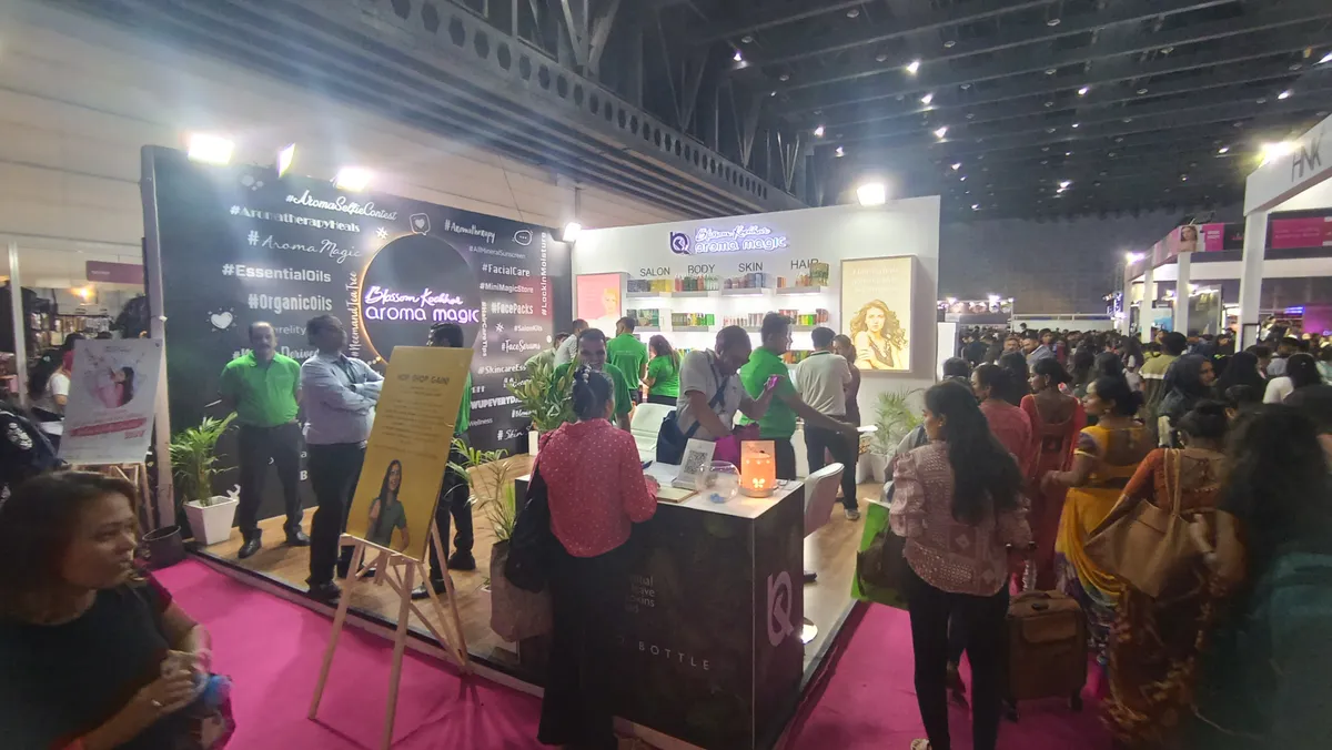 Aroma Magic booth with product displays and visitors